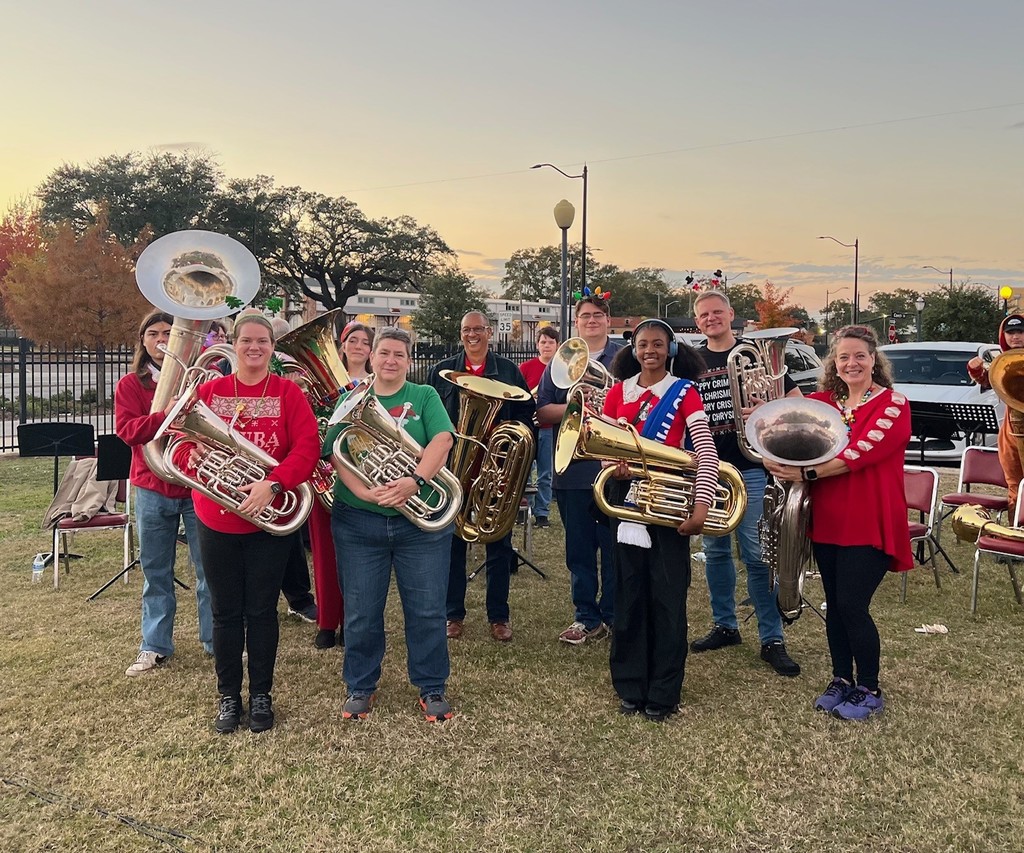A group of students and adults holding tubas and euphoniums