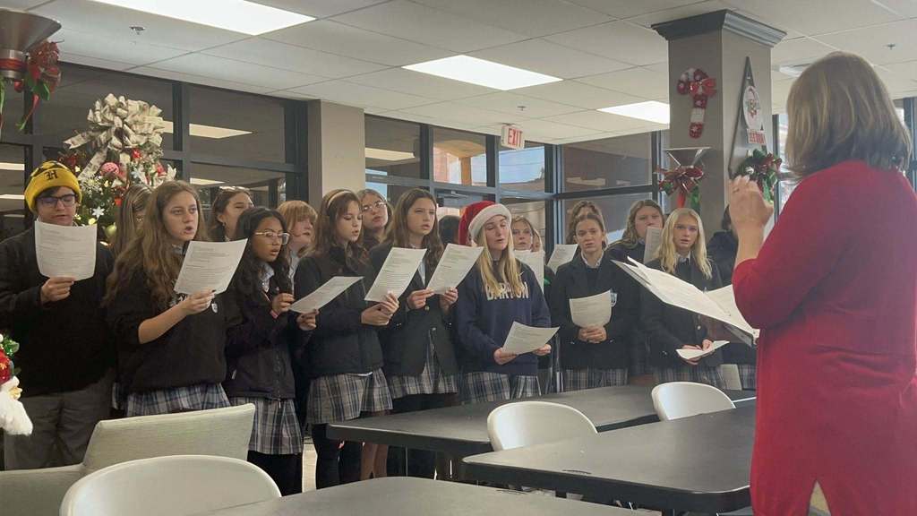 A group of students singing Christmas carols 