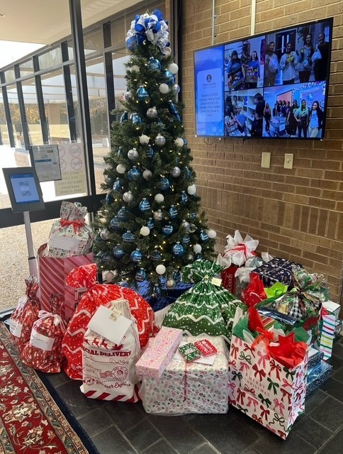 A Christmas tree with wrapped gifts beneath it