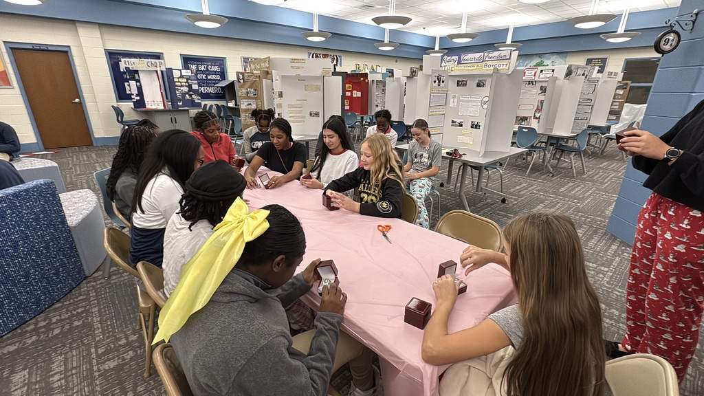 Flag football team opening their championship rings