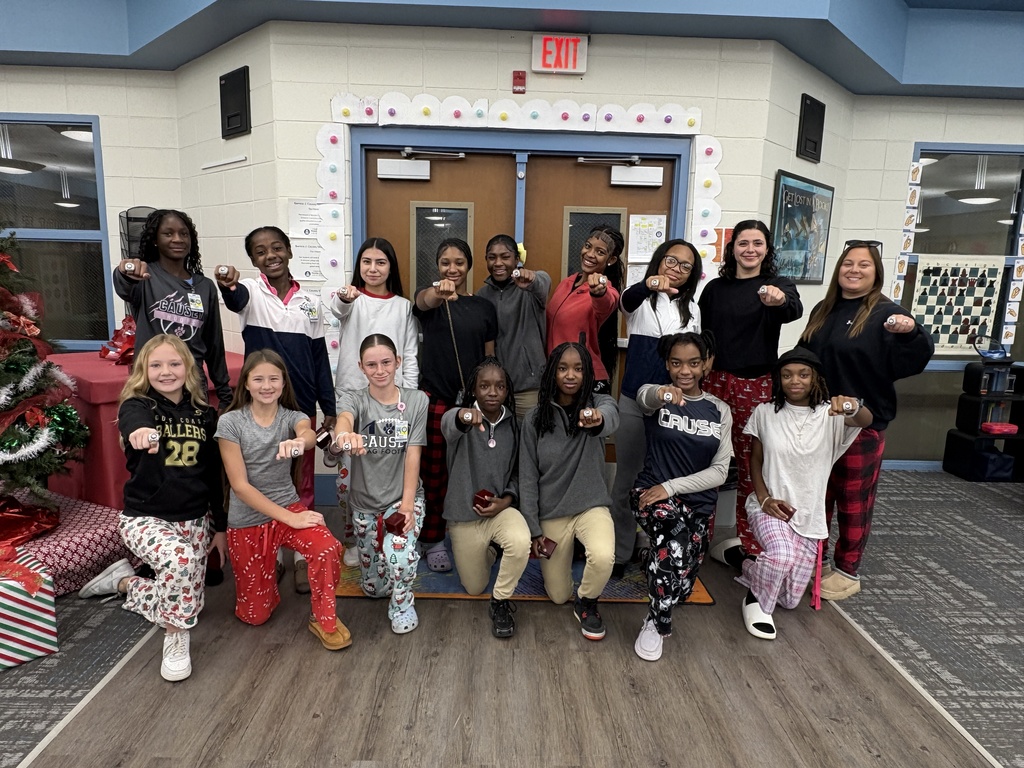 Group photo of flag football team with their championship rings