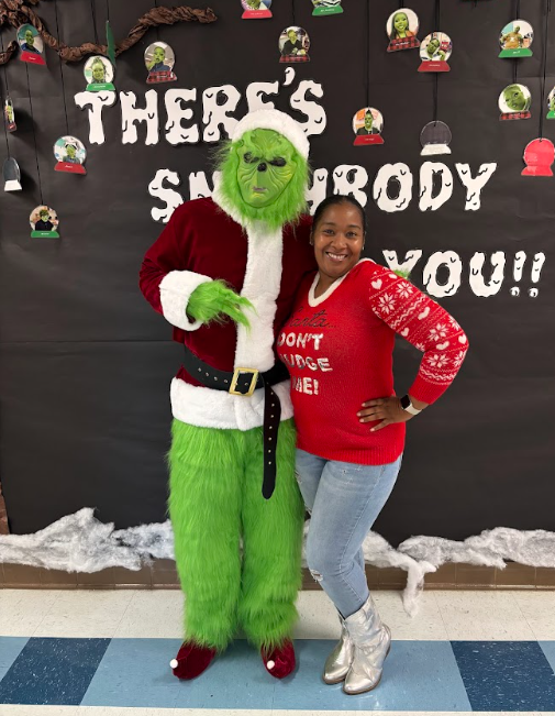 Students standing standing with the Grinch 