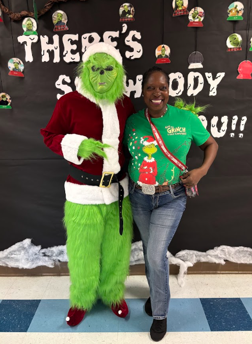 Students standing standing with the Grinch 
