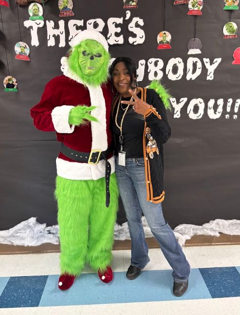 Students standing standing with the Grinch 
