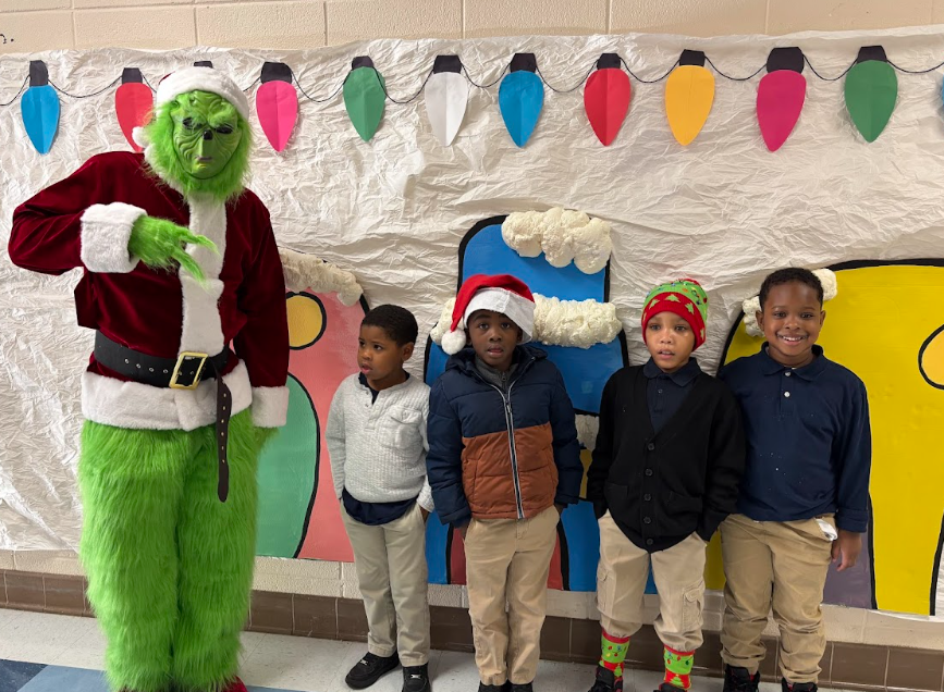 Students standing standing with the Grinch 