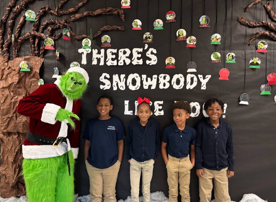 Students standing standing with the Grinch 