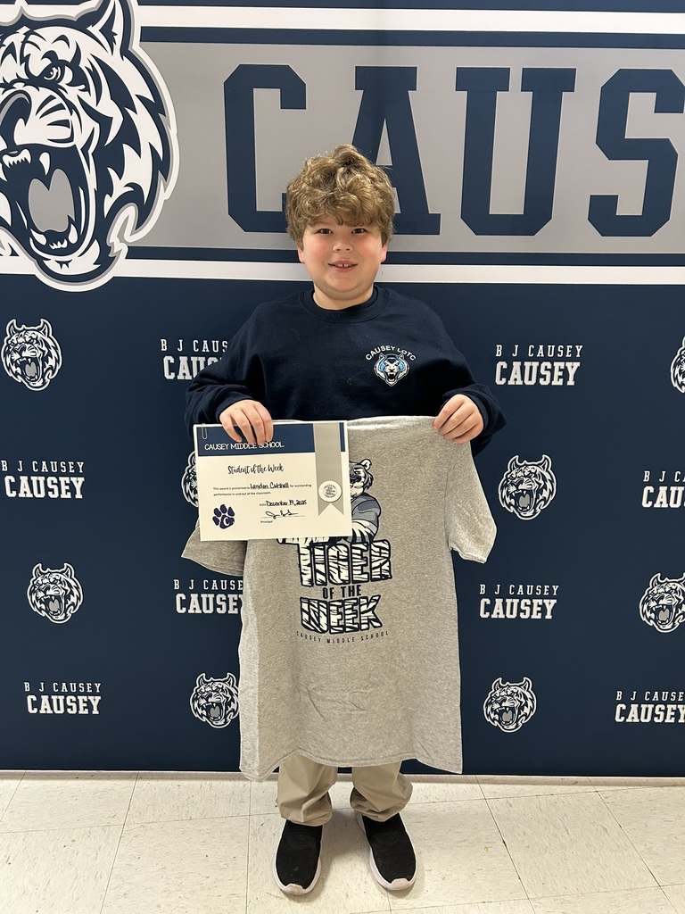 Student holding t-shirt and certificate