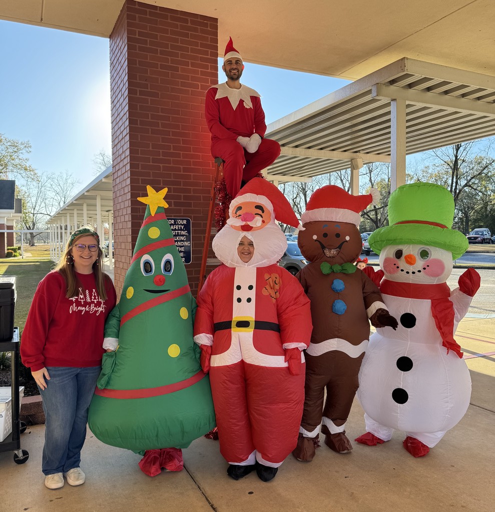 Teachers dressed in Christmas inflatable costumes and one man dressed as Elf on the Shelf