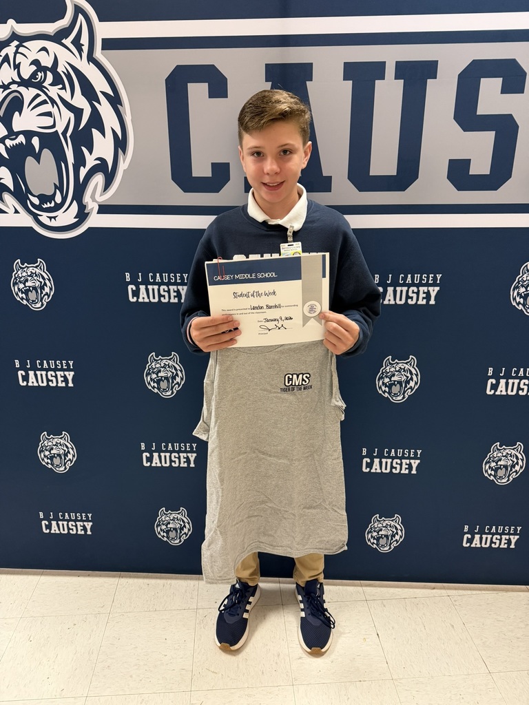 Student holding t-shirt and certificate