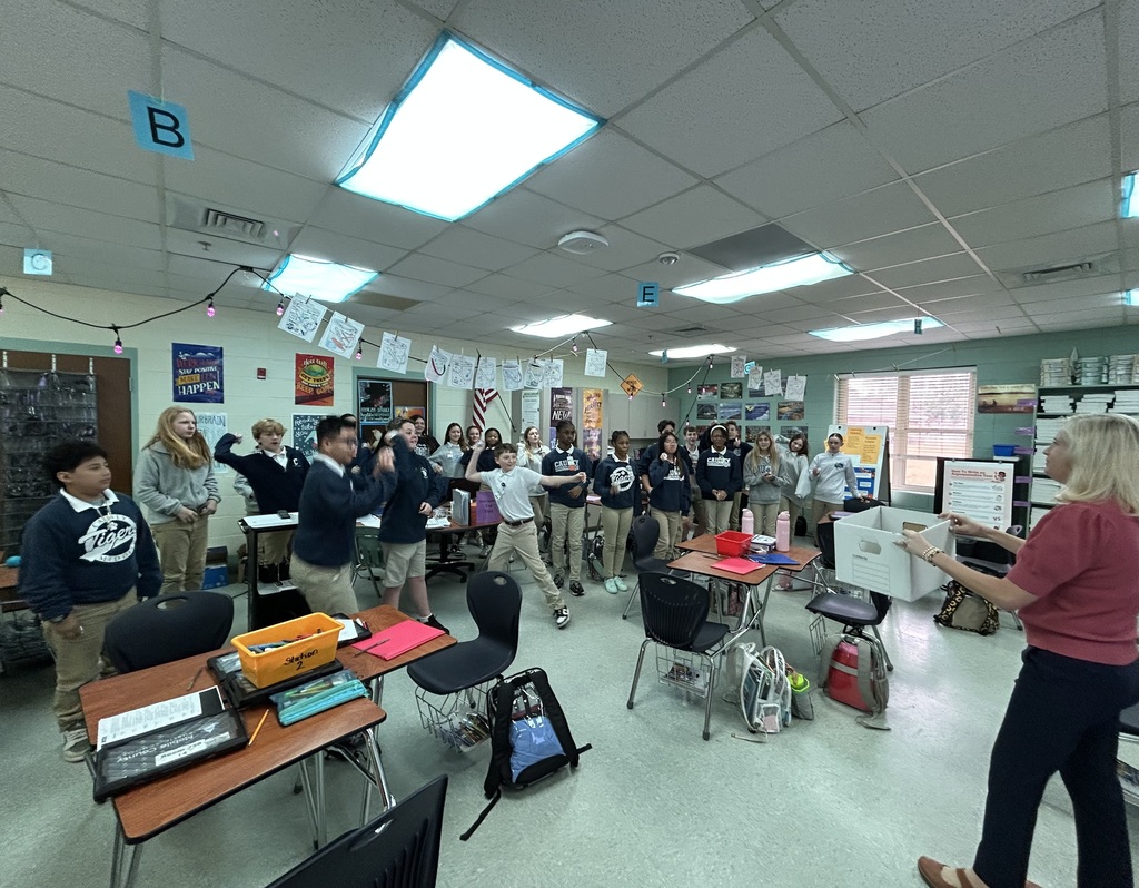 Classroom of students ready to throw paper balls