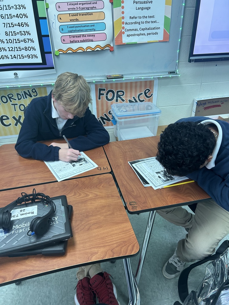 Students working at desks in a classroom