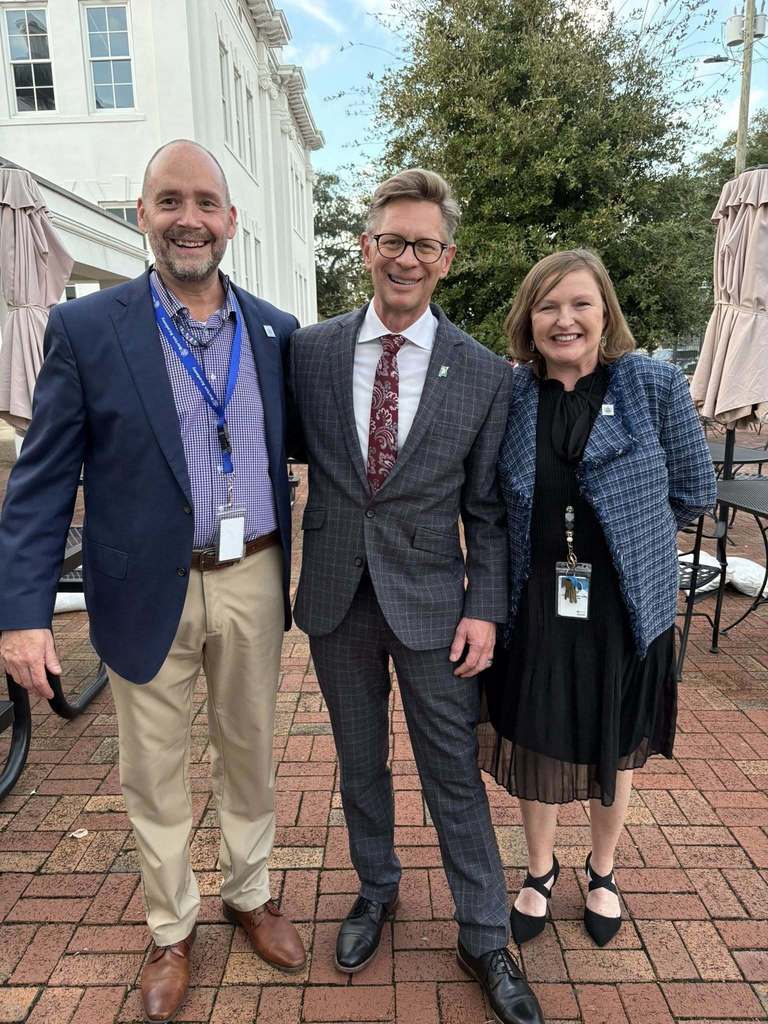 Dr. Eric Mackey stands with Barton Academy Principal Dr. Amanda Jones and Assistant Principal William Edmonds