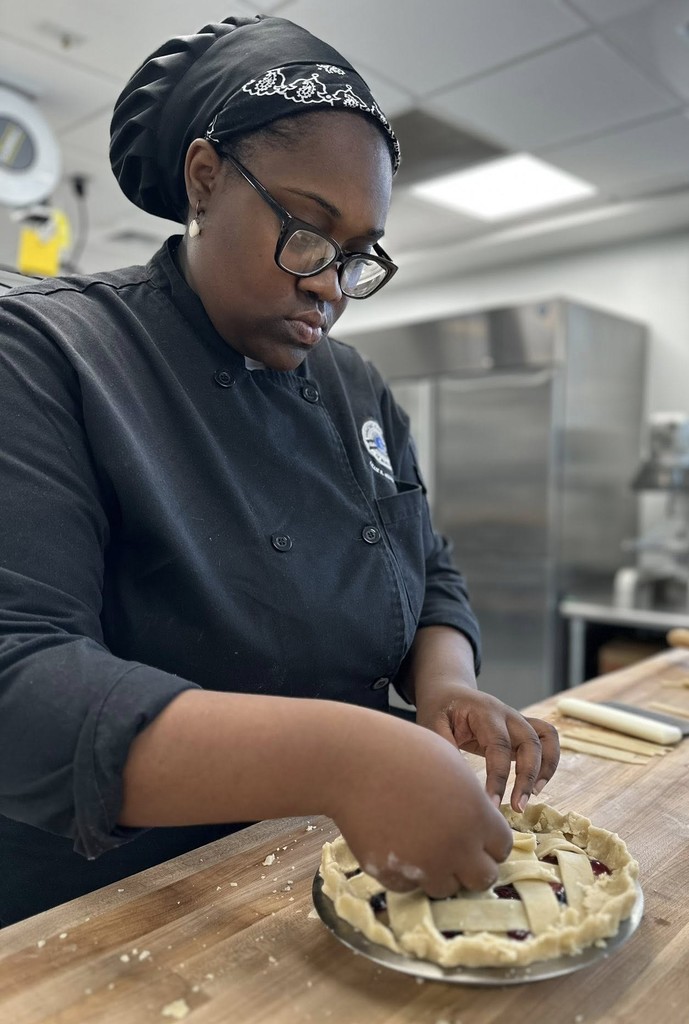 A culinary student makes a pie 