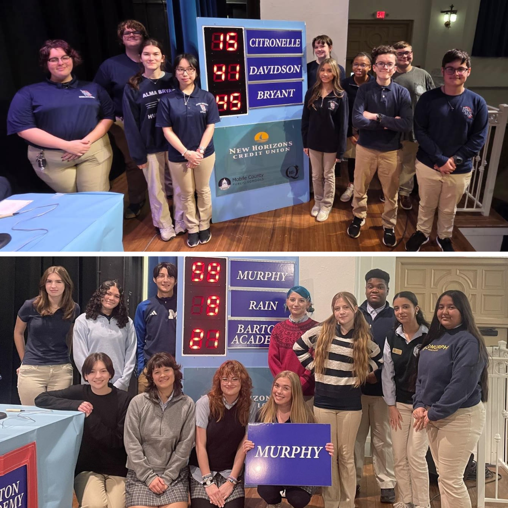 A group of students from Alma Bryant and another group from Murphy pose in front of Hi-Q scoreboards