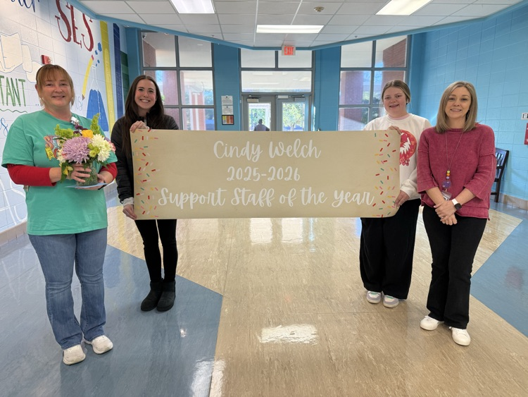 people smiling with banner 