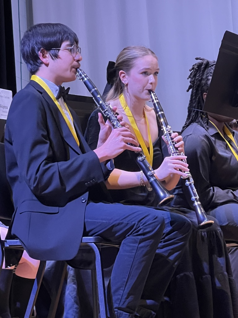 Two students playing clarinets