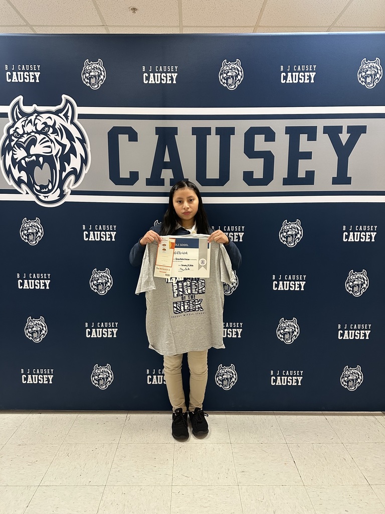Student holding t-shirt and certificate