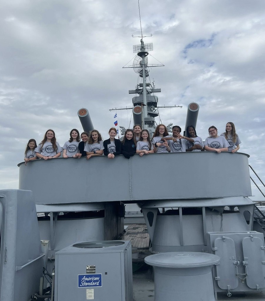 A group of students standing on a battleship