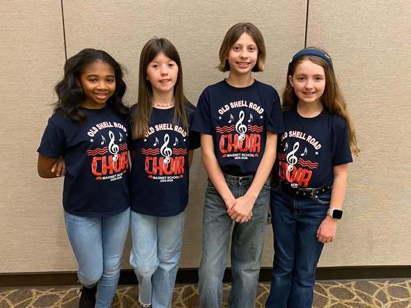Four girls in Old Shell Road Choir T-shirts
