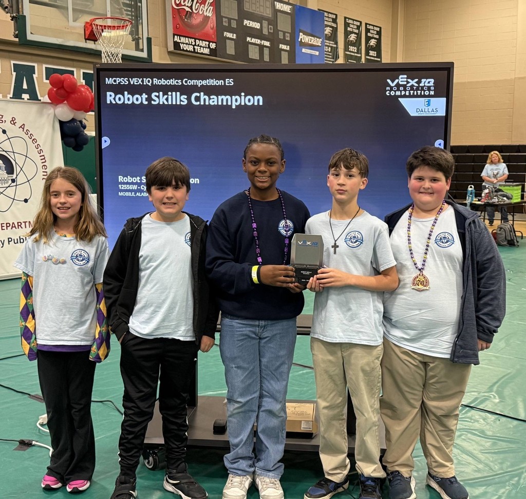 Five students holding a trophy