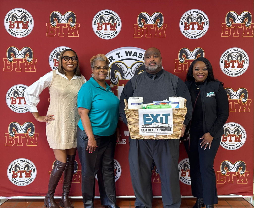 Picture of Lamoura Nettles, Vasquie Nettles, and Valerie Smith with Exit Realty Promise and Mr. Williams, Principal,. Thank you for bringing school and health supplies. 