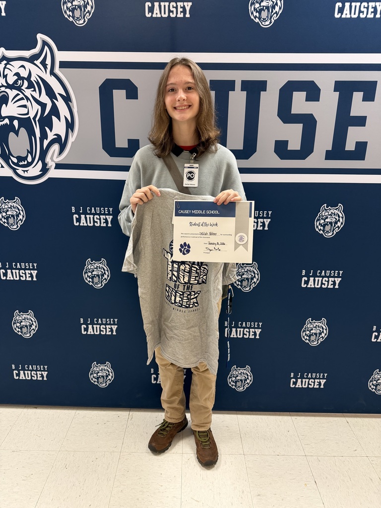 Student holding t-shirt and certificate