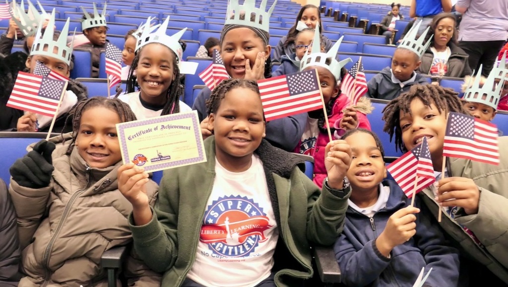 Students waving flags and holding a certificate