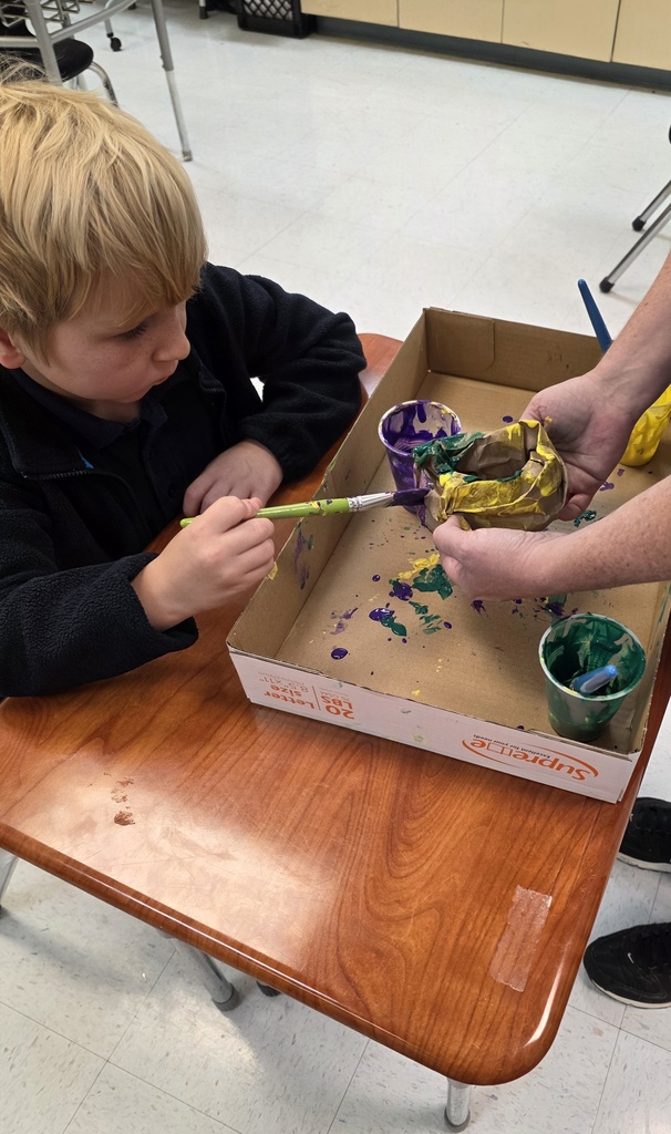 Student creating an art projects with paint 