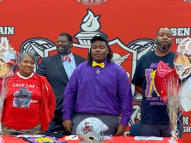 Devante Coats with his parents and football coach