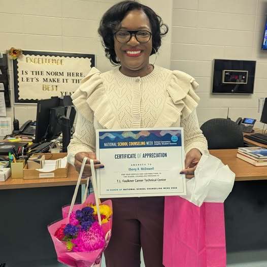 Guidance Counselor holding Certificate of Appreciation and gifts for Counselor Appreciation Week