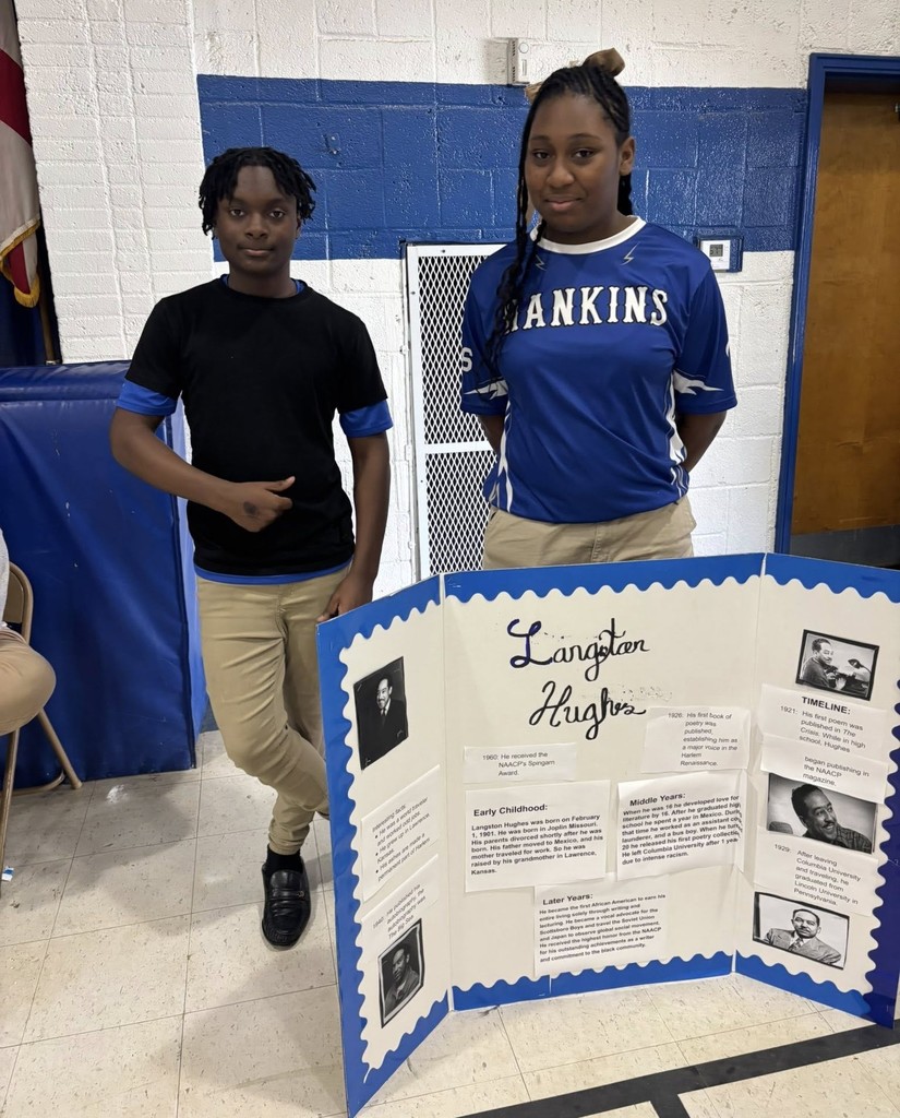 Two students with a Langston Hughes poster board