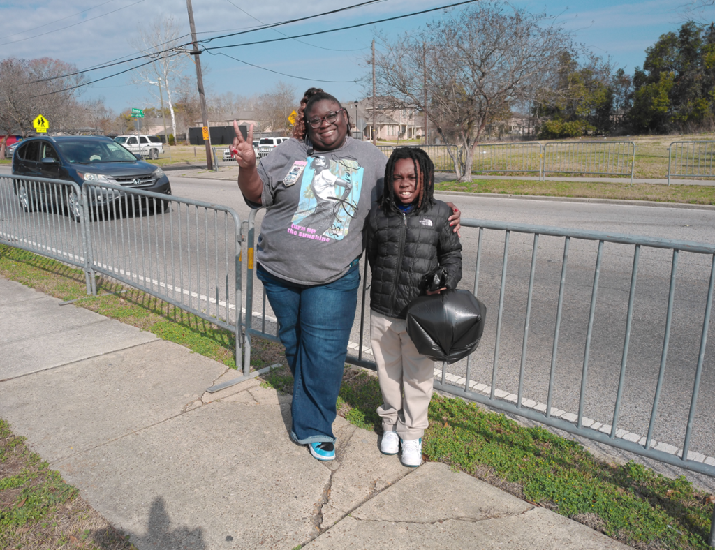 Ms. Powell standing with ne of her students before the parade