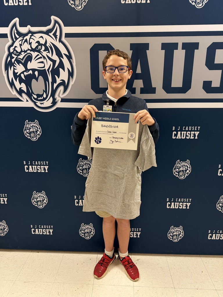 Student holding t-shirt and certificate