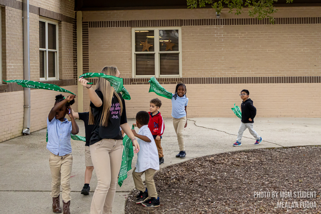 Pre-K students learning the steps and traditions to create their very own second line outside.