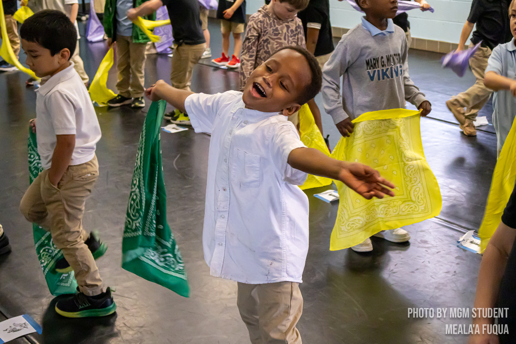 Pre-K students learning the steps and traditions to create their very own second line outside.