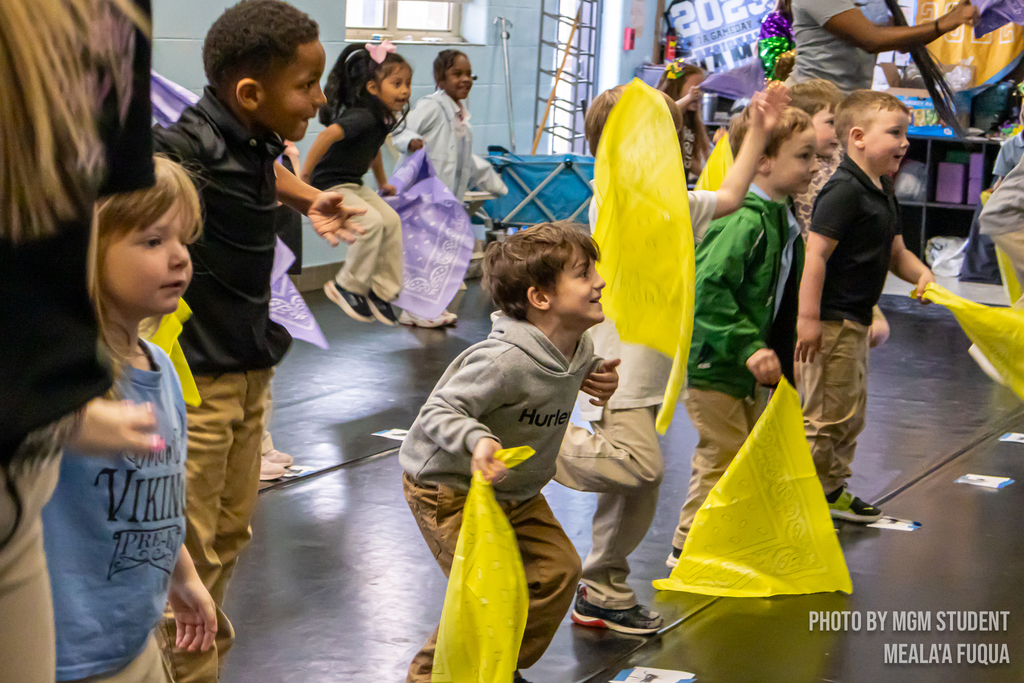 Pre-K students learning the steps and traditions to create their very own second line outside.