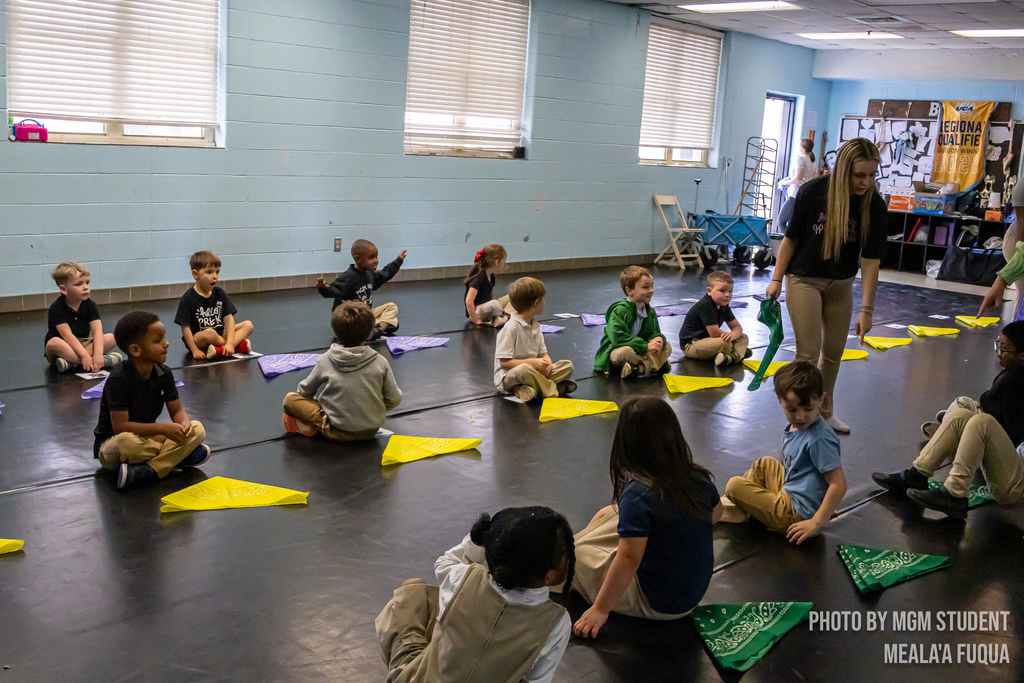 Pre-K students learning the steps and traditions to create their very own second line outside.