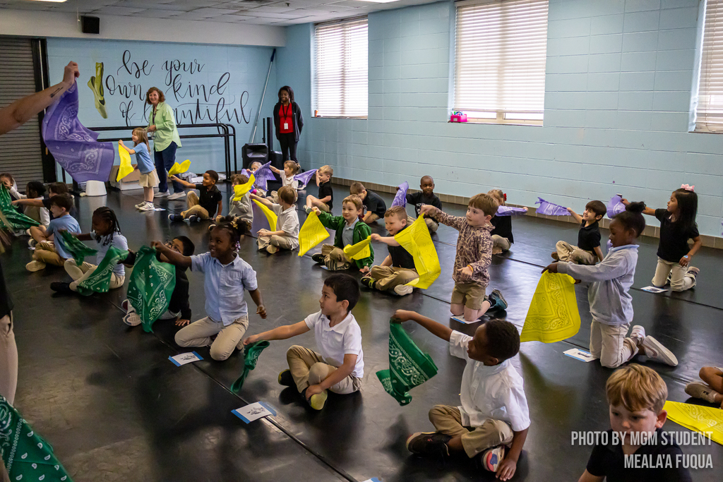 Pre-K students learning the steps and traditions to create their very own second line outside.