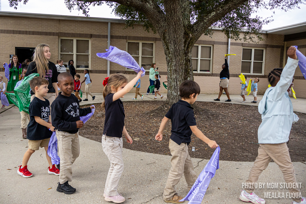 Pre-K students learning the steps and traditions to create their very own second line outside.