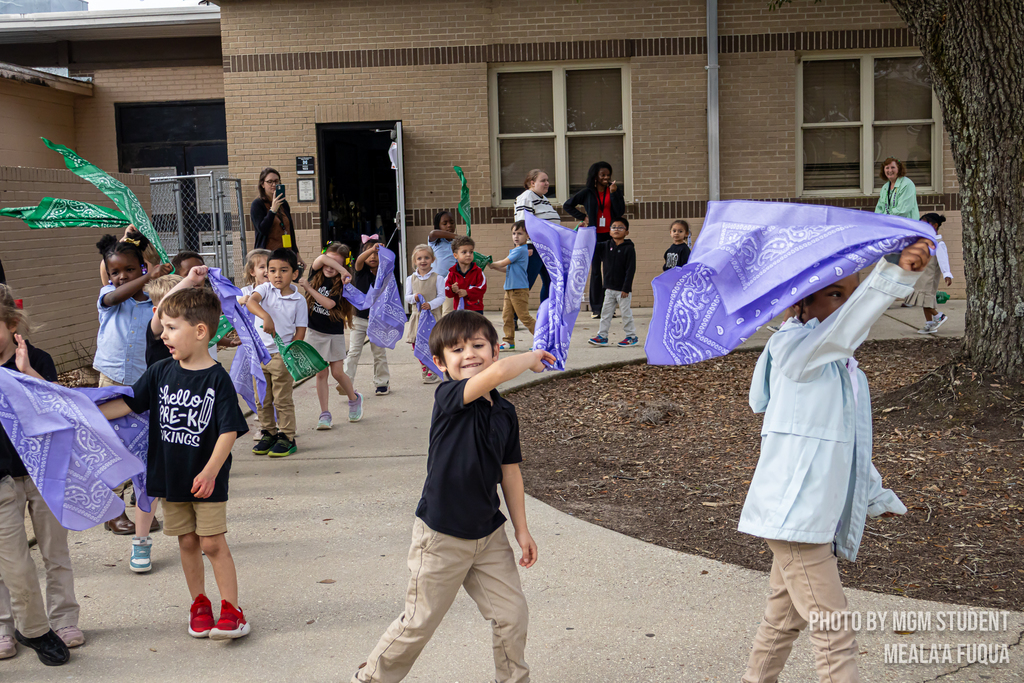Pre-K students learning the steps and traditions to create their very own second line outside.