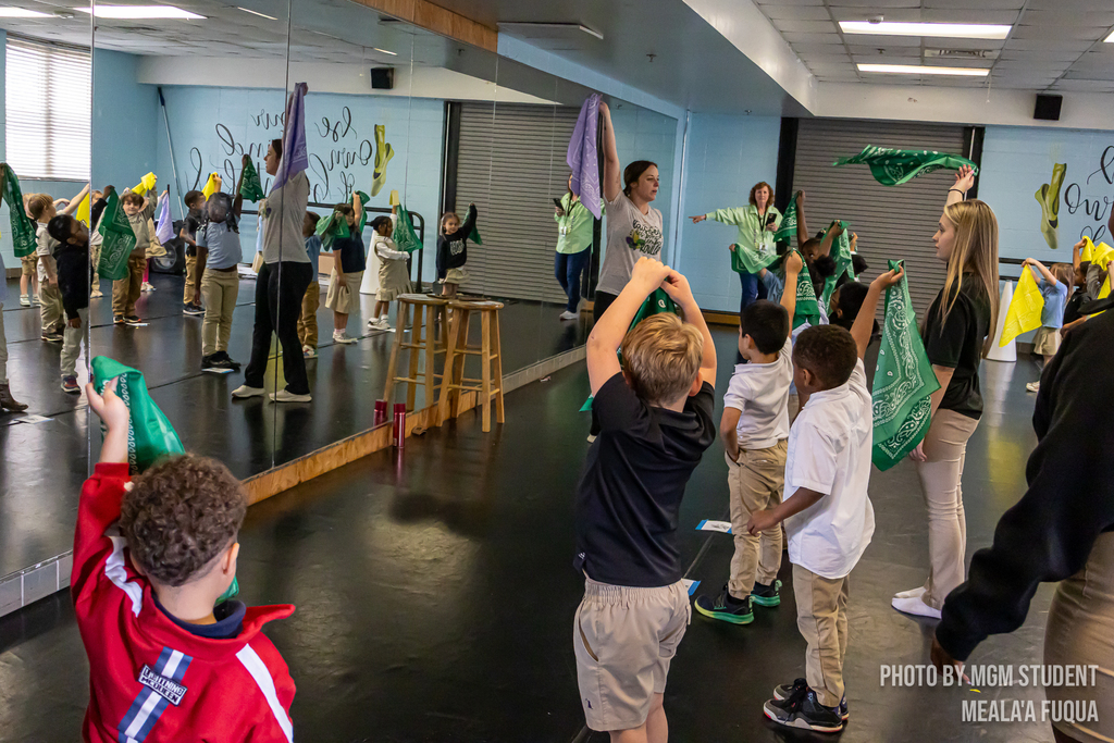 Pre-K students learning the steps and traditions to create their very own second line outside.