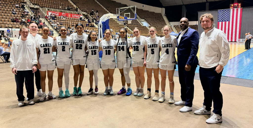 A group of girls basketball players in white jerseys