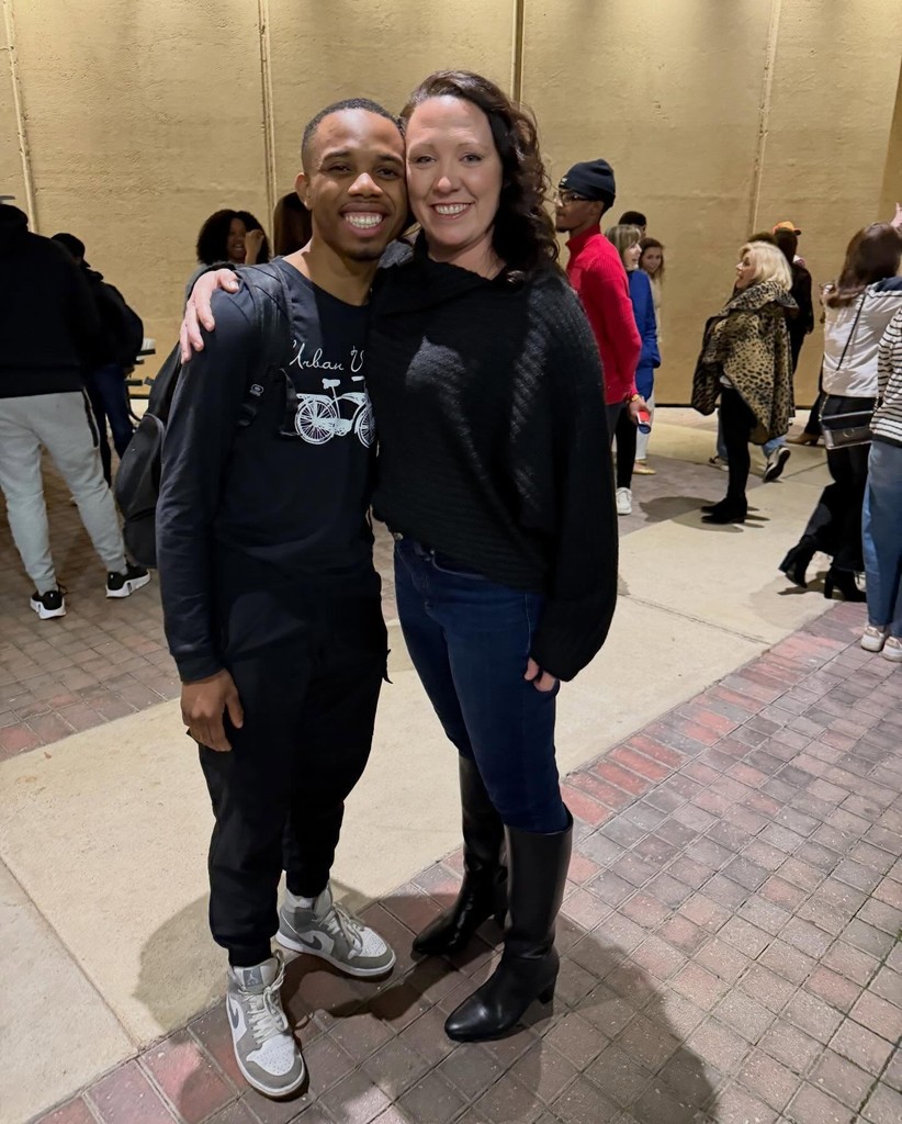 A teacher with her arm around a young man