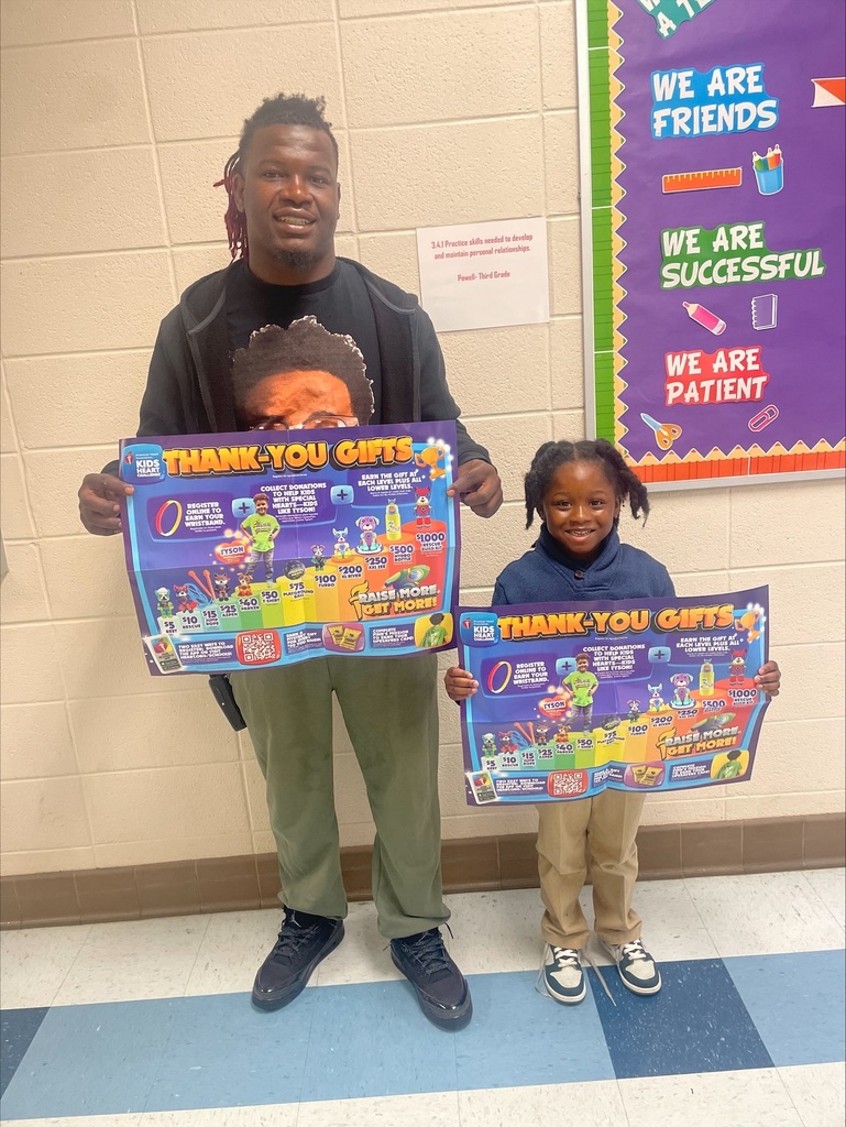 Coach Harper and a student holding up an American heart association flyer to help raise awareness to the Kids heart Challenge 