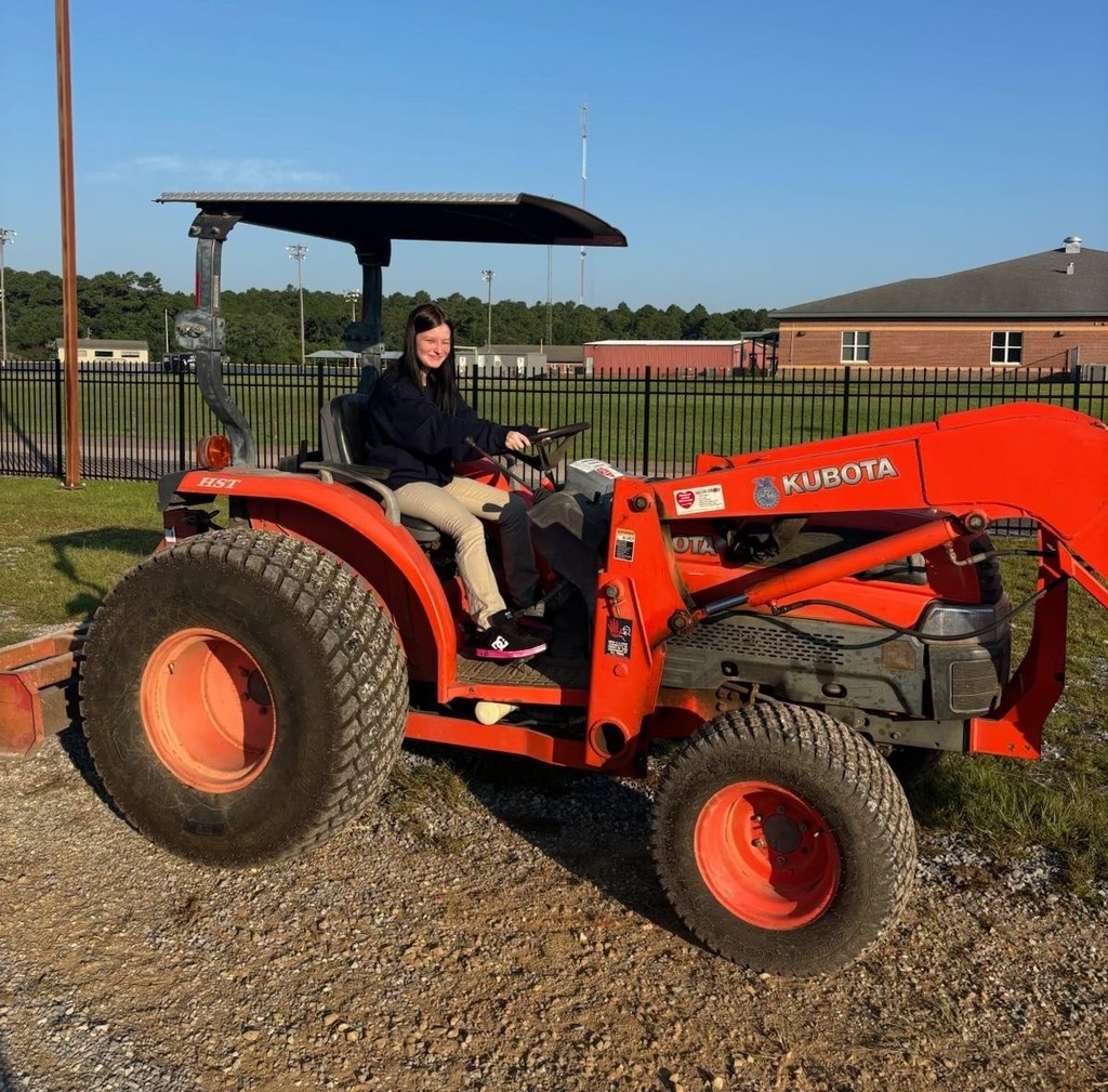 A girl driving a tractor