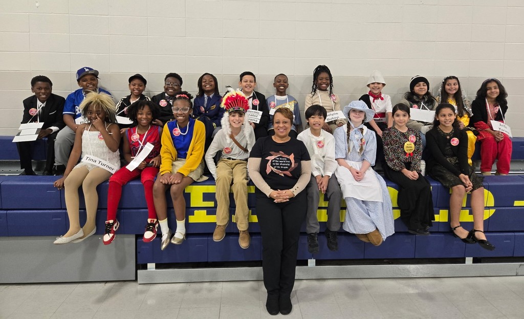 A teacher and a group of students dressed as historical figures
