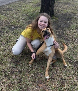 A girl petting a dog
