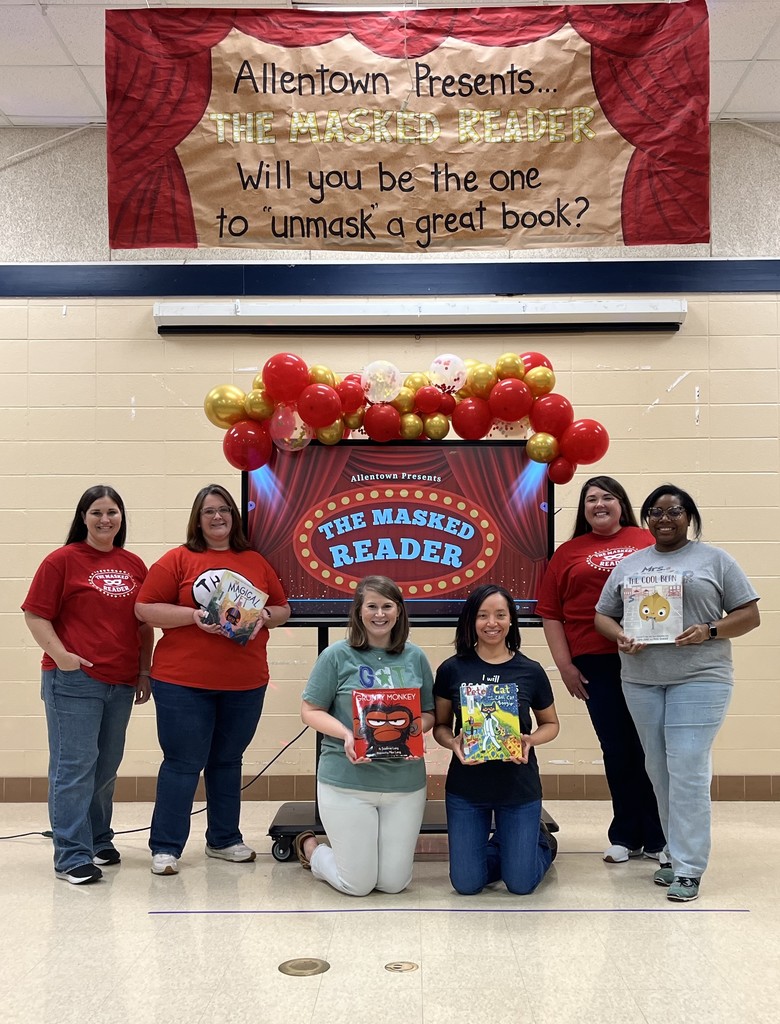 A group of teachers holding books