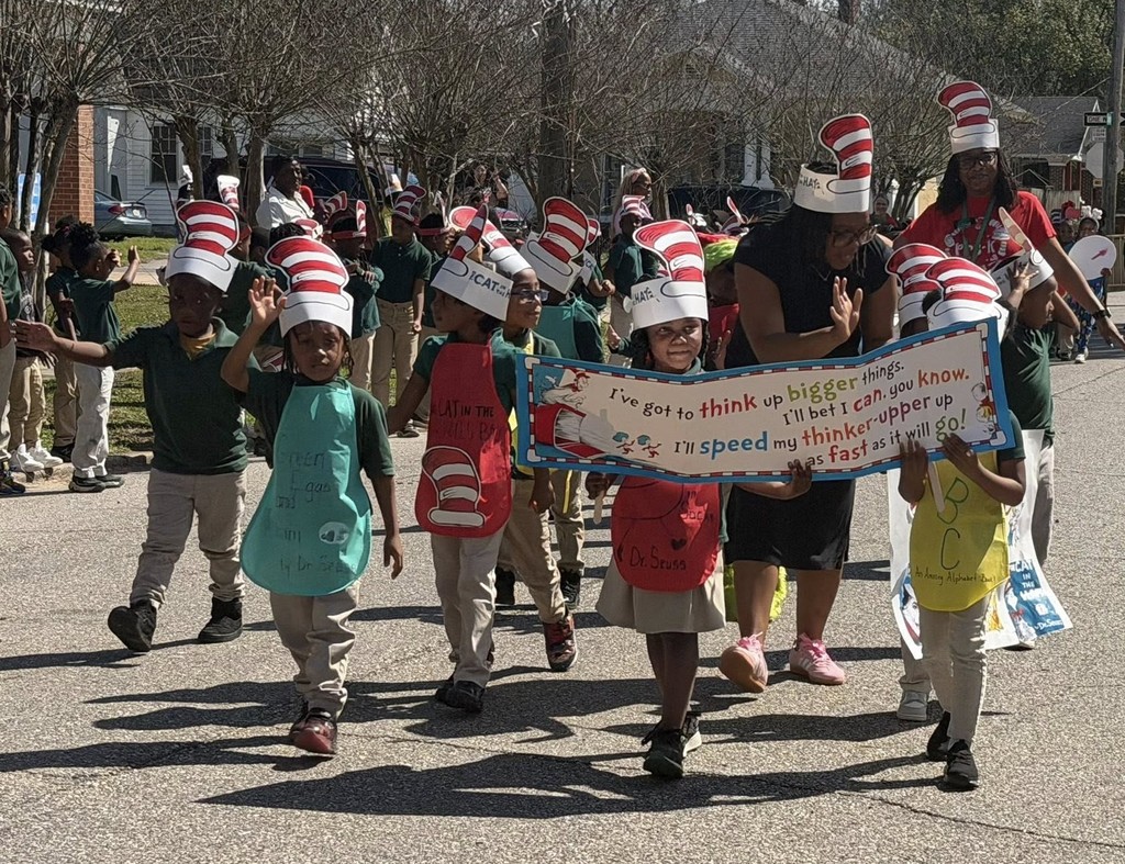 Students in Cat in the Hat hats marching in the street