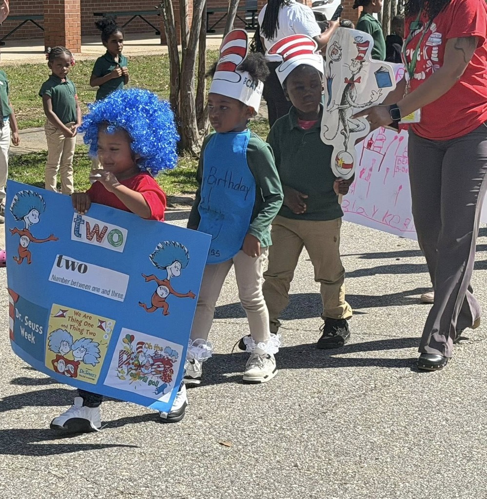 Students dressed like Dr. Seuss characters walking in the street